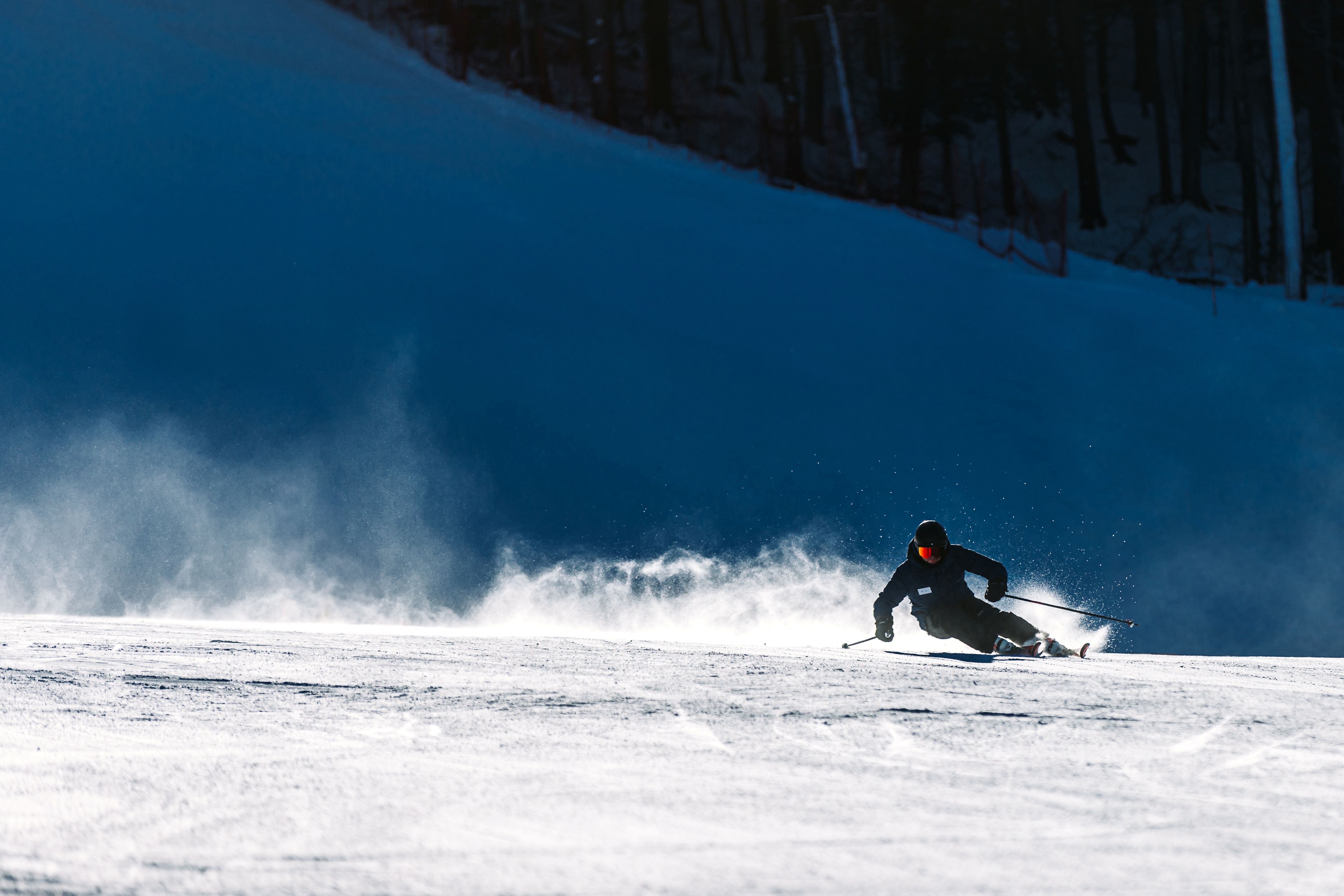 Skier Carving down a slope.